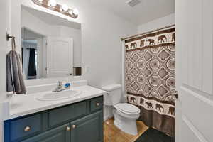 Bathroom with tile patterned flooring, vanity, and toilet