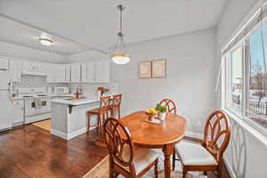 Dining space featuring dark hardwood / wood-style flooring and sink