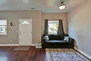 Entrance foyer with hardwood / wood-style flooring