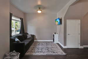 Living room with dark hardwood / wood-style flooring