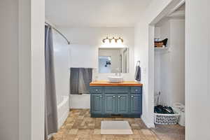 Bathroom with vanity and tub / shower combination