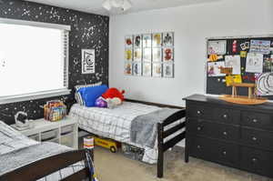 Bedroom featuring light carpet and ceiling fan