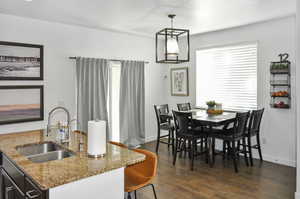 Dining space with sink and dark hardwood / wood-style floors