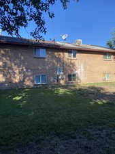 Back of house featuring a lawn