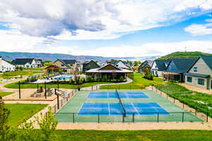 View of sport court with a lawn and a mountain view