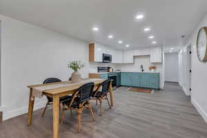 Dining space featuring light hardwood / wood-style flooring and sink