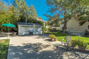 View of patio featuring area for grilling and an outdoor structure