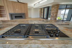 Kitchen featuring stainless steel gas stovetop