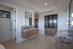 Bathroom with vanity and a tray ceiling