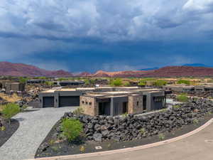 View of front of house featuring a mountain view and a garage