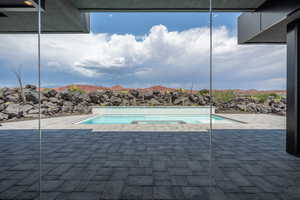 View of swimming pool featuring a mountain view and a patio area