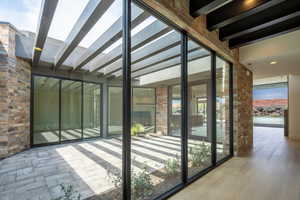 Unfurnished sunroom with beam ceiling