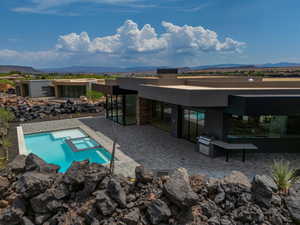 View of pool with a mountain view, area for grilling, an in ground hot tub, and a patio area