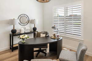 Home office with hardwood / wood-style floors