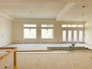 Empty room with plenty of natural light and a raised ceiling