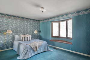 Primary bedroom with a bay window & window seat