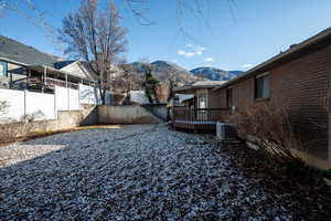 Back of  home & covered deck with mountain views