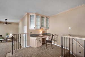 Built-in desk with glass fronted cabinets