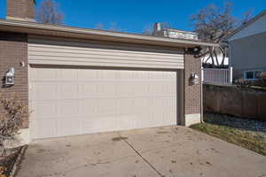 2-car garage with sconce light fixtures