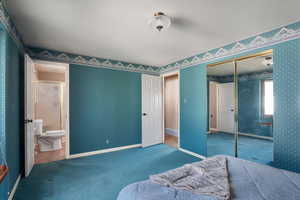 Primary bedroom closet & entrance to primary bath