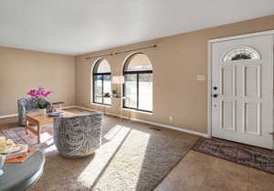 Entry, arched windows & living room