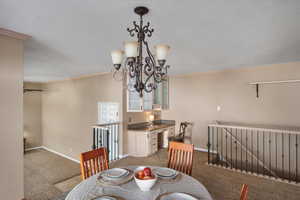 Semi-formal dining to built-in desk, stairs to basement & down to sunroom