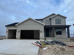 View of front of home featuring a porch and a garage