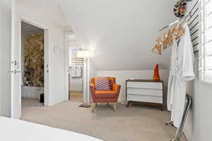 Carpeted bedroom with lofted ceiling