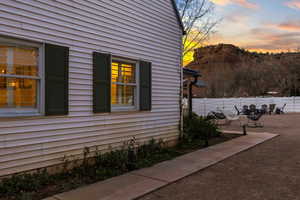 Property exterior at dusk featuring a patio area