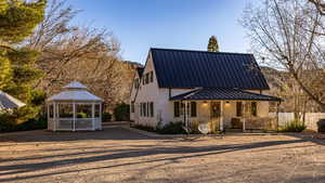 View of front of house with covered porch and a gazebo