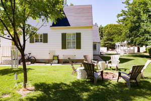 Rear view of property with a lawn