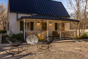 Back of property featuring a porch and a patio