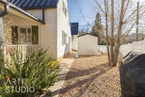 View of property exterior featuring a storage unit