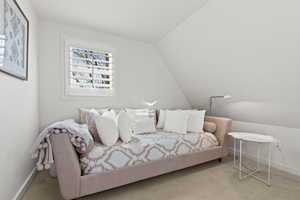 Carpeted bedroom with lofted ceiling