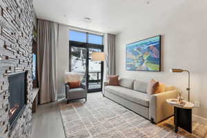 Living room featuring hardwood / wood-style floors, expansive windows, and a fireplace