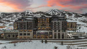 Snow covered building with a mountain view