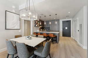 Dining area featuring light hardwood / wood-style floors and an inviting chandelier