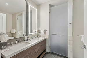 Bathroom with tile patterned flooring and vanity