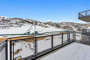 Snow covered back of property featuring a mountain view