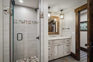 Bathroom featuring vanity and an enclosed shower