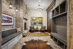 Mudroom featuring a notable chandelier