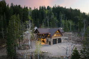 Log-style house with a garage and a deck