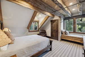 Bedroom with beamed ceiling, carpet flooring, and wood ceiling