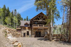 Back of property featuring a wooden deck