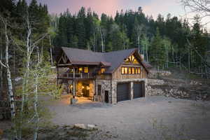 View of front of property with a garage and a deck