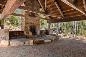 View of patio / terrace featuring an outdoor stone fireplace