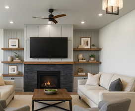 Living room with ceiling fan, a fireplace, recessed lighting, and wood finished floors