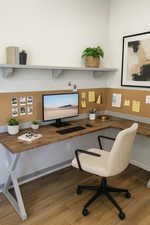 Home office with wood finished floors and built in desk