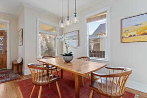 Dining space featuring hardwood / wood-style floors and ornamental molding