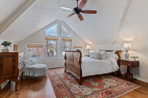 Bedroom featuring hardwood / wood-style floors, a textured ceiling, and ceiling fan